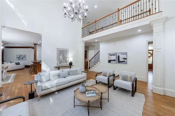 a living room with furniture and a chandelier