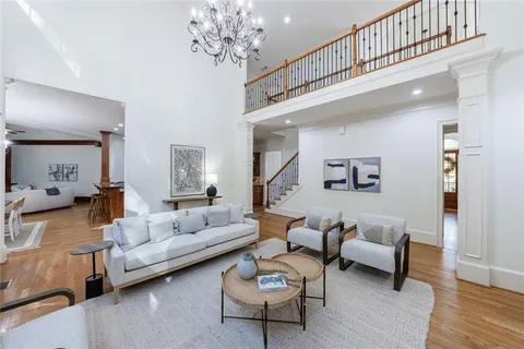 a living room with furniture and a chandelier