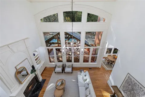 a kitchen with stainless steel appliances granite countertop a sink a stove and a wooden floors