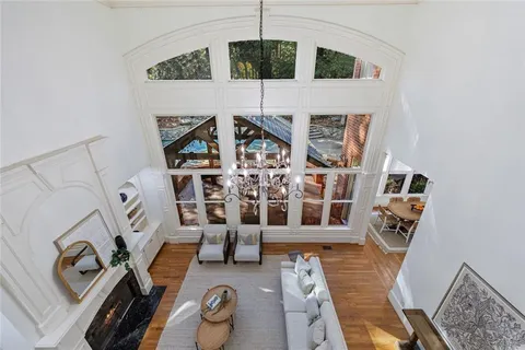 a kitchen with stainless steel appliances granite countertop a sink a stove and a wooden floors