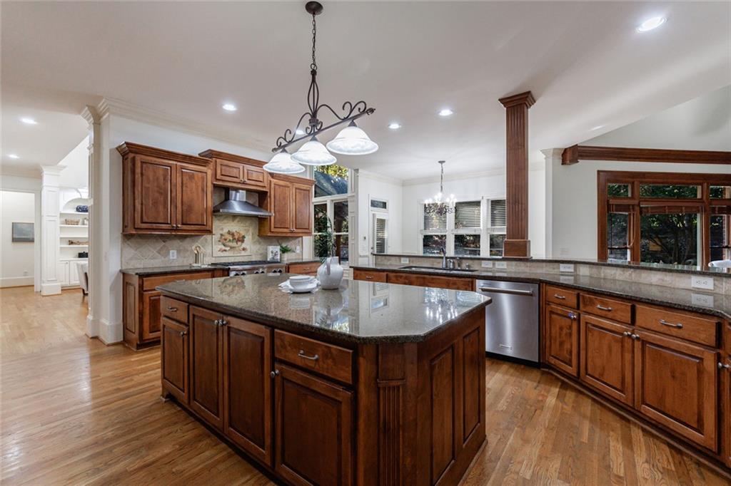 2893 Thurleston Lane Duluth, GA 30097 - Photo 19 of 53 a kitchen with stainless steel appliances granite countertop a sink a stove and a wooden floors