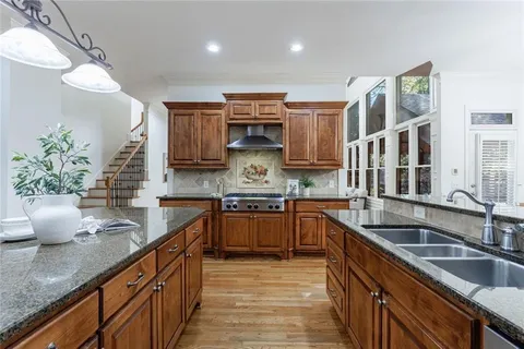 a kitchen with stainless steel appliances granite countertop a stove and a microwave
