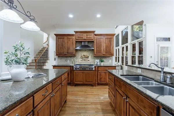 a kitchen with stainless steel appliances granite countertop a stove and a microwave