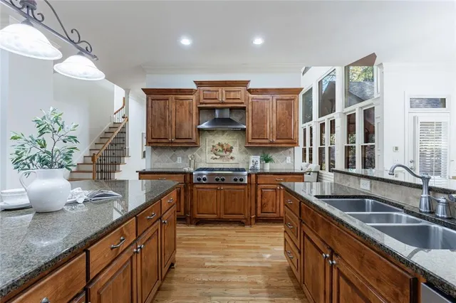 a kitchen with stainless steel appliances granite countertop a stove and a refrigerator