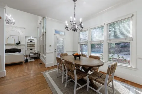 a living room with furniture a fireplace and a large window