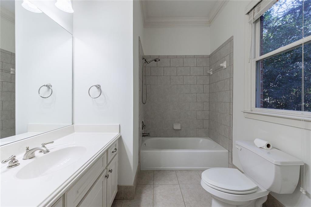 2893 Thurleston Lane Duluth, GA 30097 - Photo 34 of 53 a bathroom with a bathtub shower sink vanity mirror and toilet