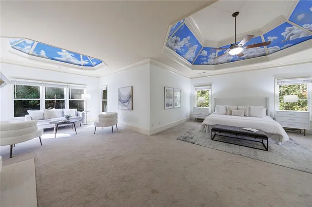 a living room with furniture a fireplace and a large window