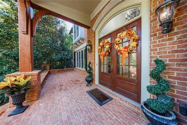 a view of a porch with furniture and floor to ceiling window