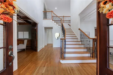 a view of entryway and hall with wooden floor