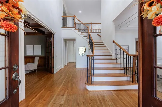 a view of entryway and hall with wooden floor
