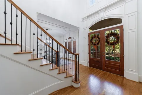 a view of front door with wooden floor and stairs