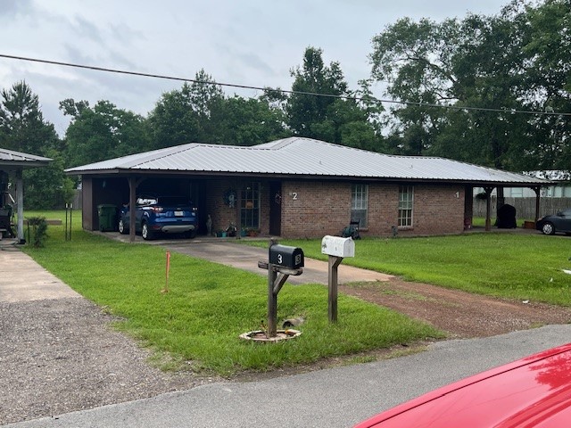 1003 Maple Avenue Cleveland, TX 77327 - Photo 1 of 7 a front view of a house with a yard table and chairs