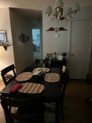 a close view of a table and chairs in the kitchen