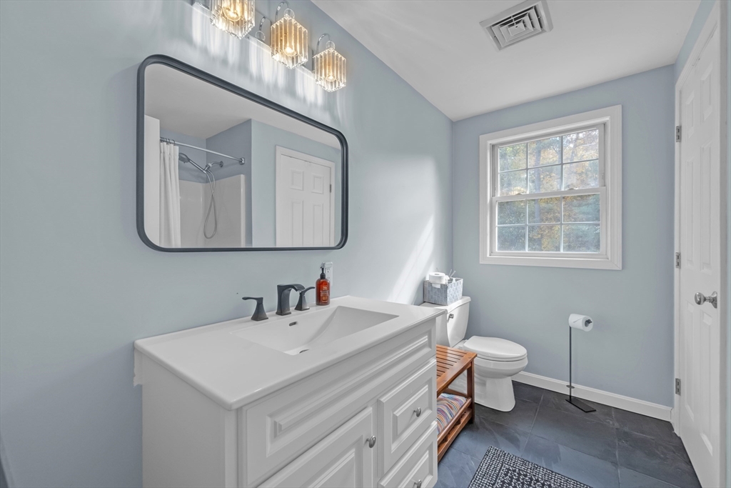 99 Breakneck Road Sturbridge, MA 01566 - Photo 14 of 28 a bathroom with a toilet sink and mirror