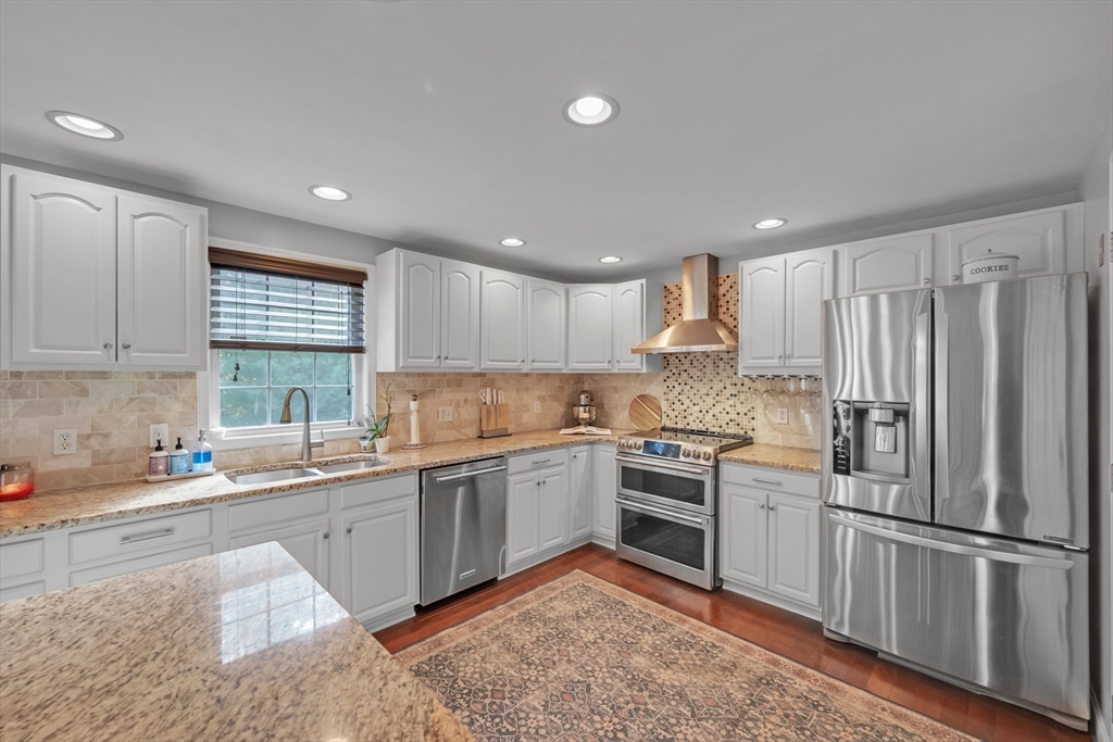 99 Breakneck Road Sturbridge, MA 01566 - Photo 5 of 28 a kitchen with a sink stainless steel appliances white cabinets and a window