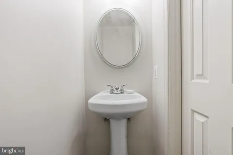 a view of a hallway with wooden floor and furniture