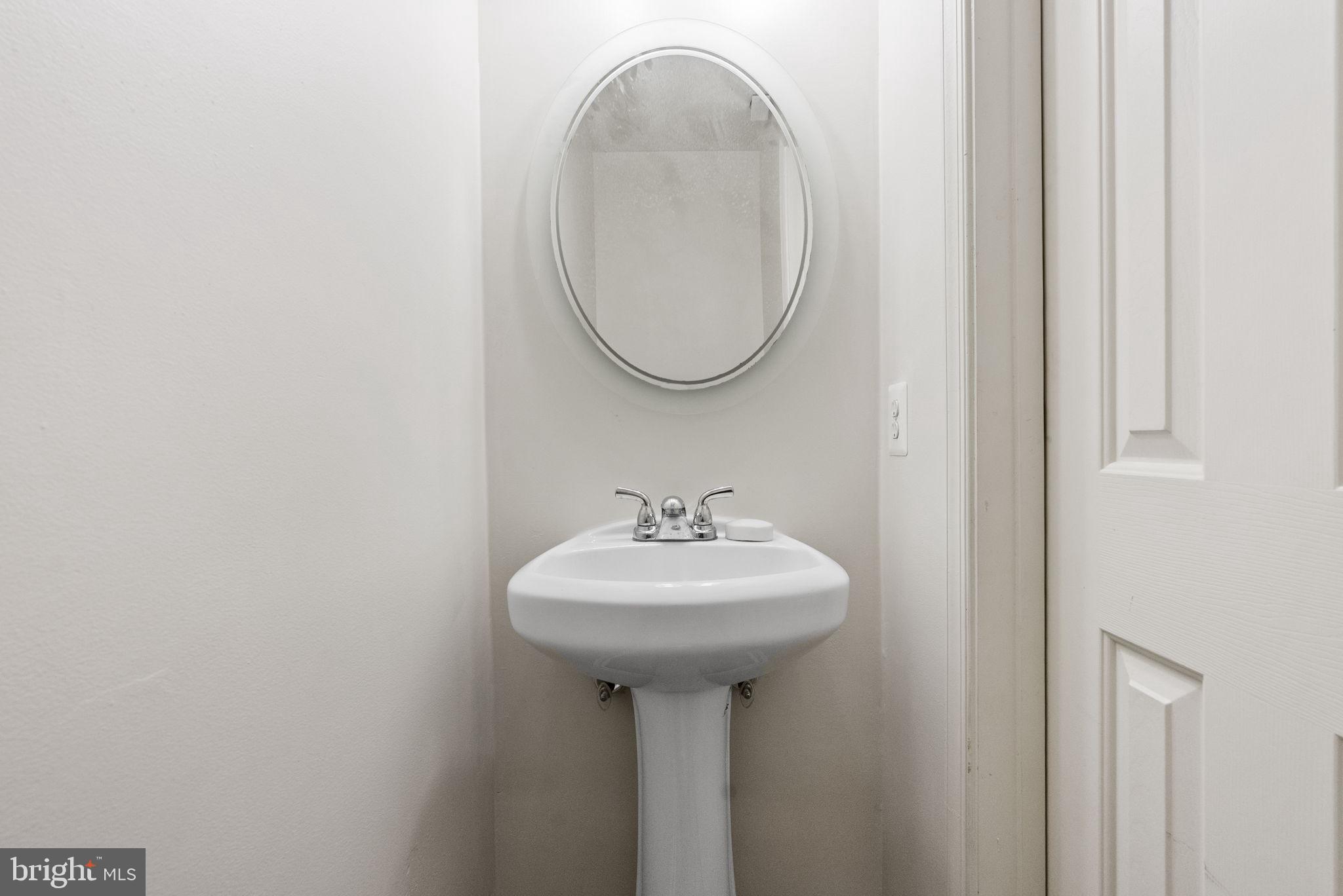 27 Branford Way Coatesville, PA 19320 - Photo 17 of 44 a bathroom with a sink a mirror and a window