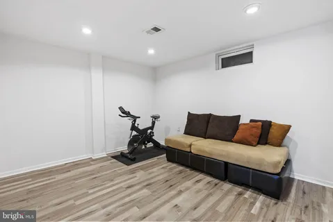 a living room with a couch and a wooden floor