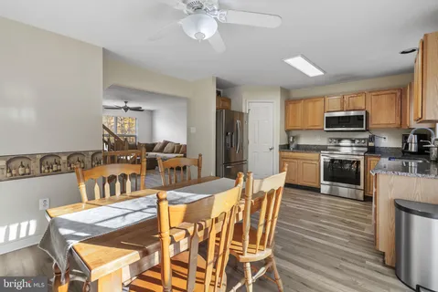 a view of a dining room with furniture and wooden floor