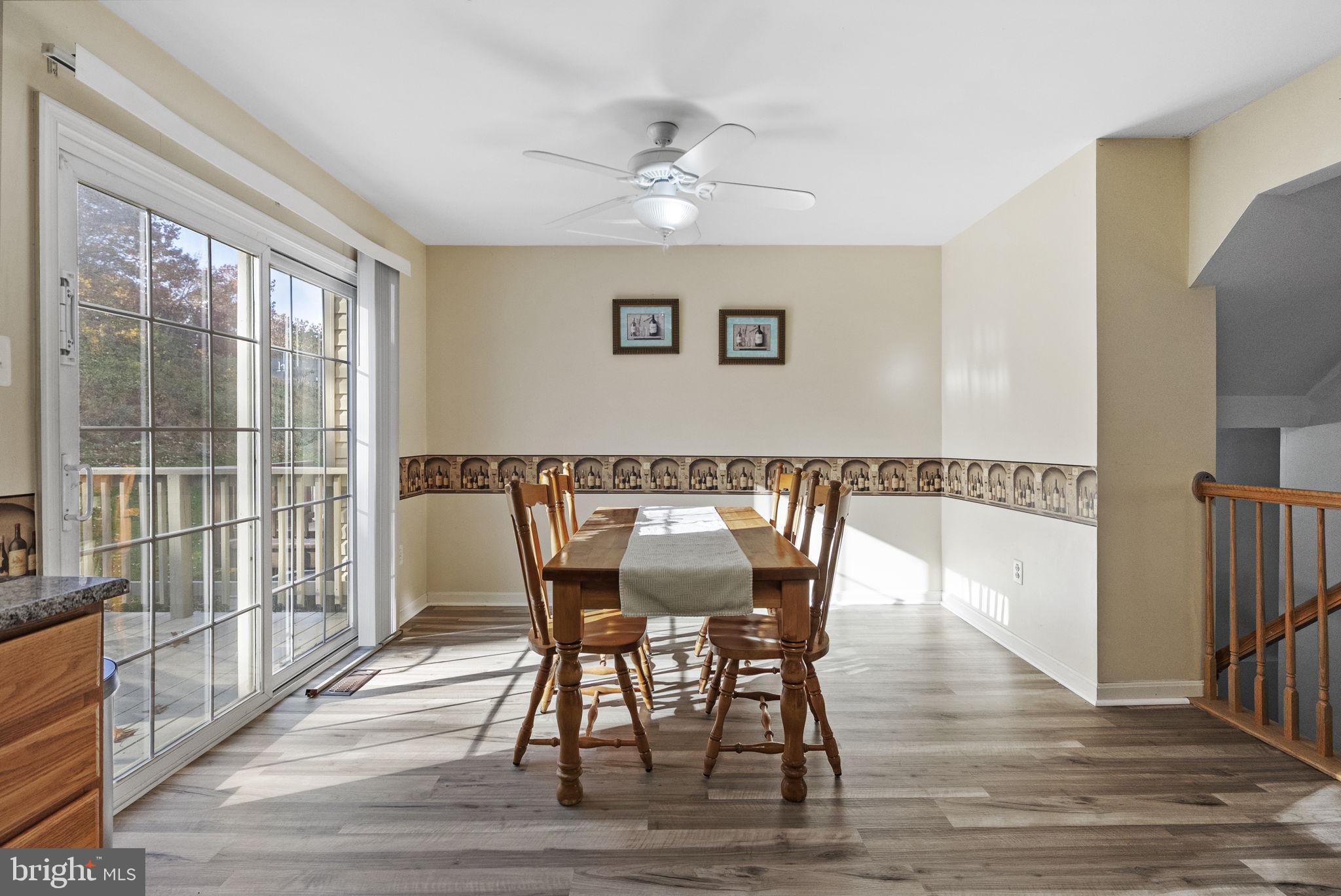 27 Branford Way Coatesville, PA 19320 - Photo 10 of 44 a view of a dining room with furniture a chandelier and wooden floor