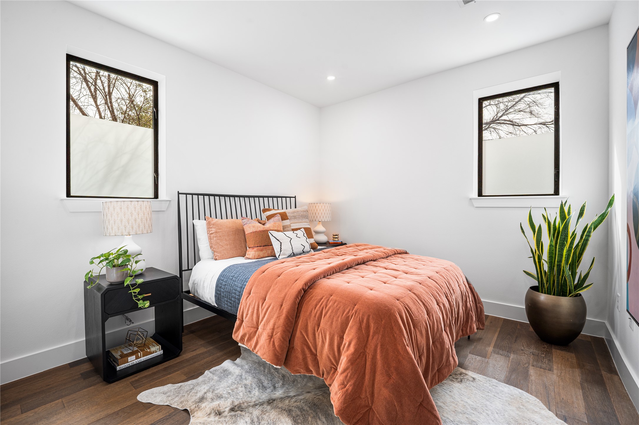 1615 East 7th Street, Unit 208 Austin, TX 78702 - Photo 12 of 30 Bedroom featuring dark wood finished floors, recessed lighting, and multiple windows