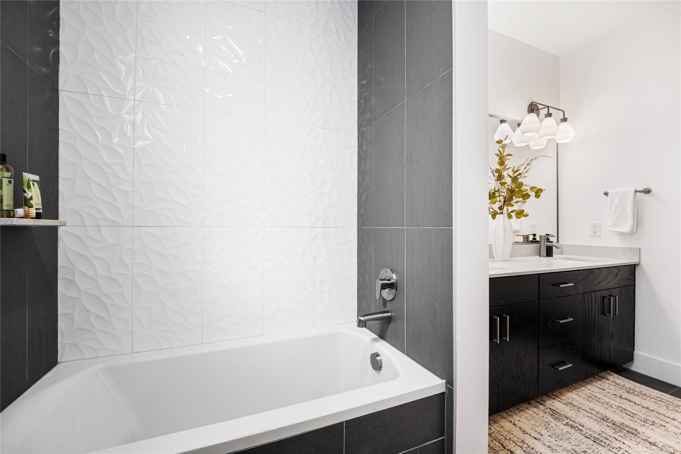 1615 East 7th Street, Unit 208 Austin, TX 78702 - Photo 18 of 30 Bathroom featuring double vanity and a relaxing tiled tub