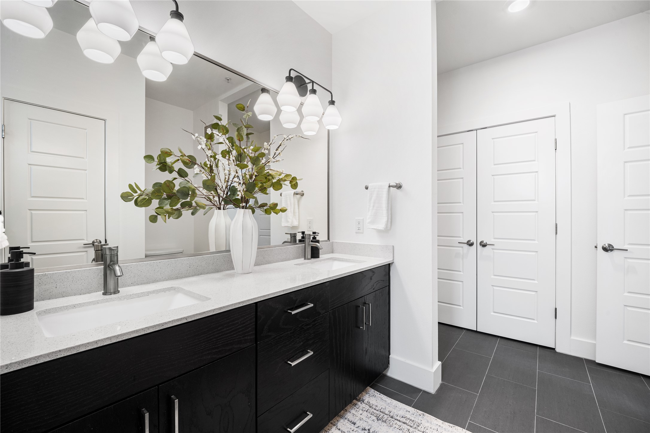 1615 East 7th Street, Unit 208 Austin, TX 78702 - Photo 19 of 30 Bathroom featuring double vanity and dark tile patterned floors