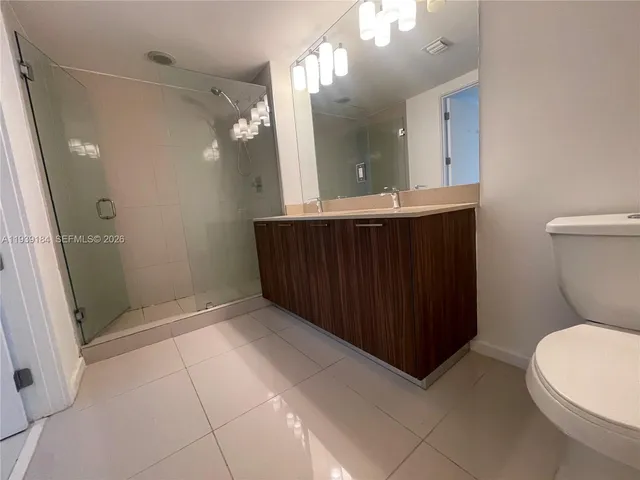 a bathroom with a sink a toilet a mirror and vanity