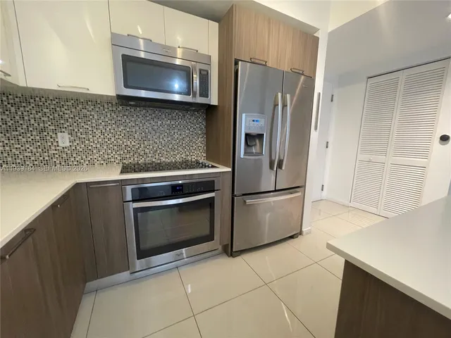 a kitchen with a refrigerator sink and microwave