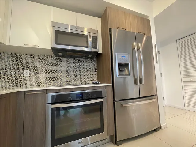 a kitchen with appliances and cabinets