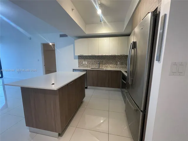 a kitchen with stainless steel appliances a sink stove and refrigerator
