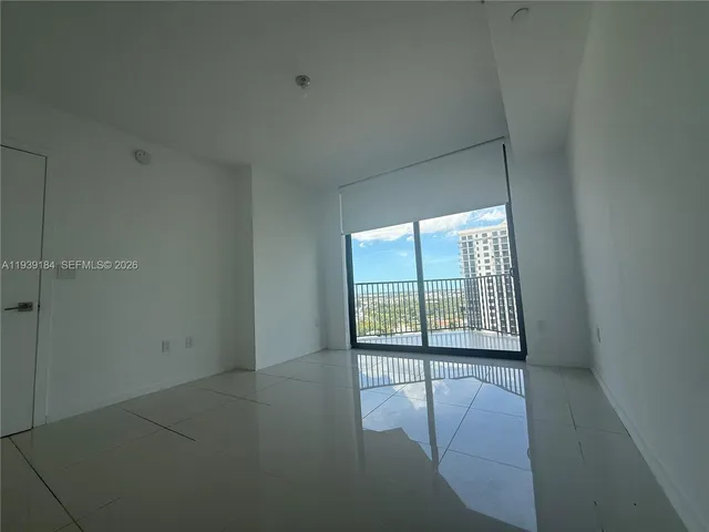 a view of an empty room with a sliding door