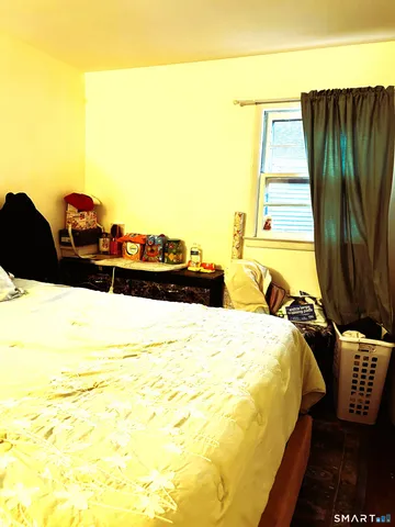 a bed sitting in a bedroom next to a window