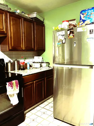 a kitchen with a sink and a refrigerator