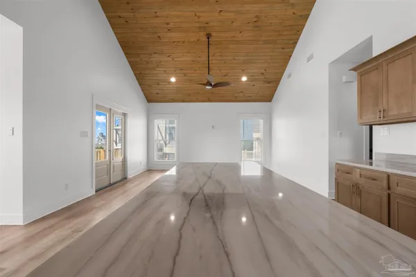 a view of a kitchen with wooden floor and a sink