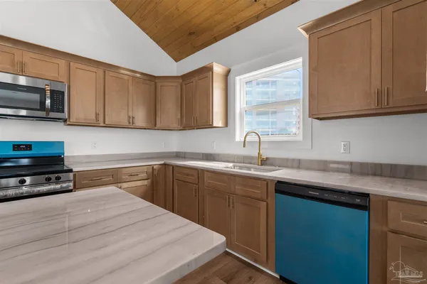 a kitchen with stainless steel appliances granite countertop a sink stove and microwave