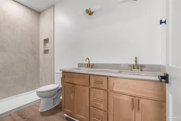 a bathroom with a toilet a sink and mirror