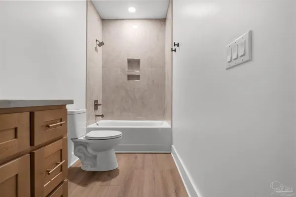 a bathroom with a toilet a sink and bathtub