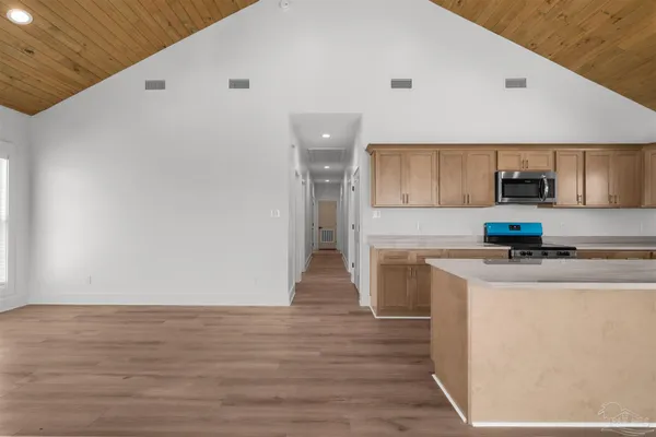 a kitchen with granite countertop a sink and a stove top oven