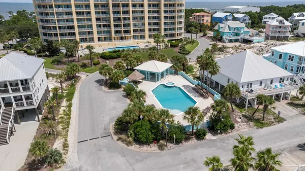 an aerial view of a house with a yard and outdoor seating