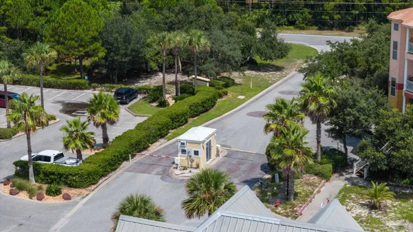 an aerial view of a house with a yard and tennis court