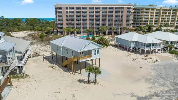 a view of a house with backyard and sitting area