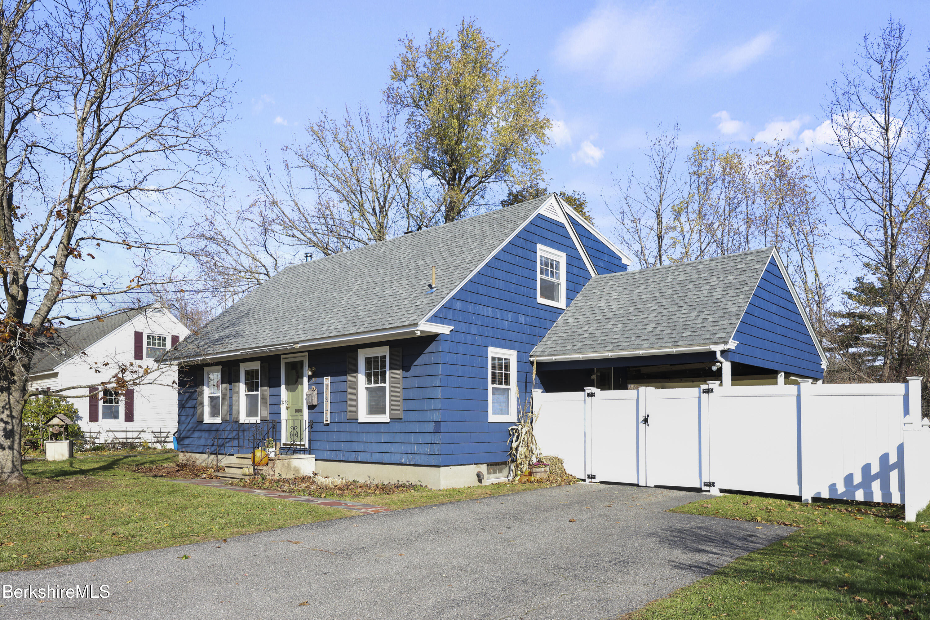 39 Lowden Street Pittsfield, MA 01201 - Photo 1 of 42 a front view of a house with a garden and trees