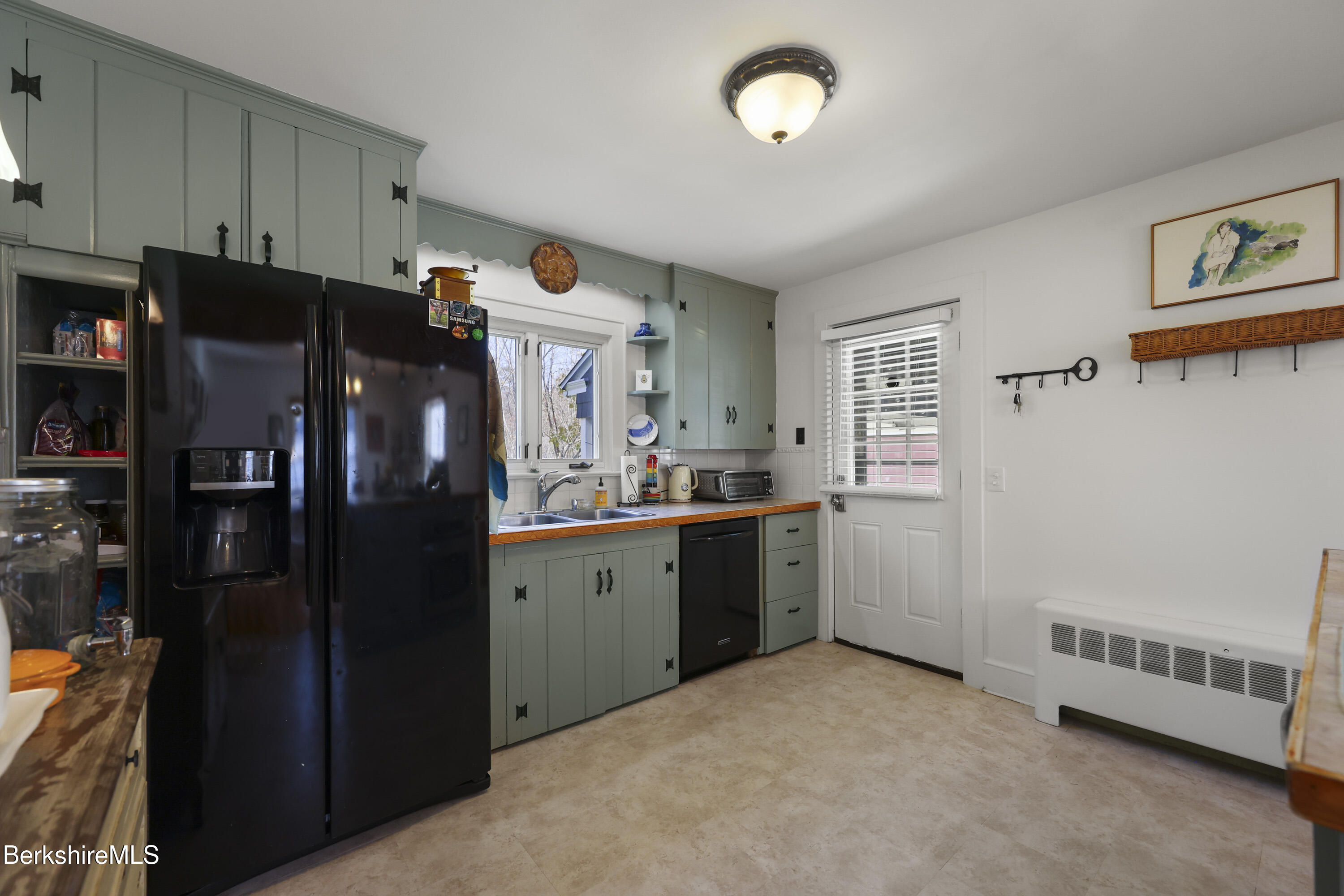 39 Lowden Street Pittsfield, MA 01201 - Photo 13 of 42 a kitchen with a refrigerator and cabinets