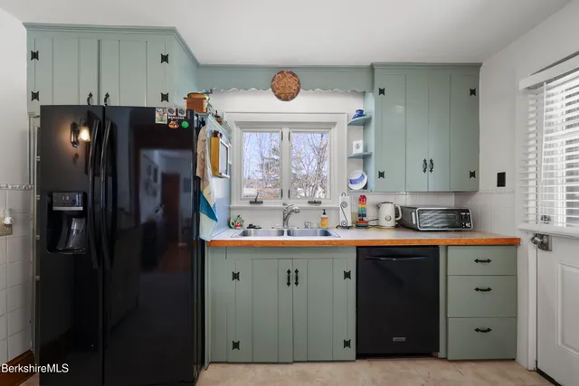 a kitchen with stainless steel appliances a refrigerator and a sink