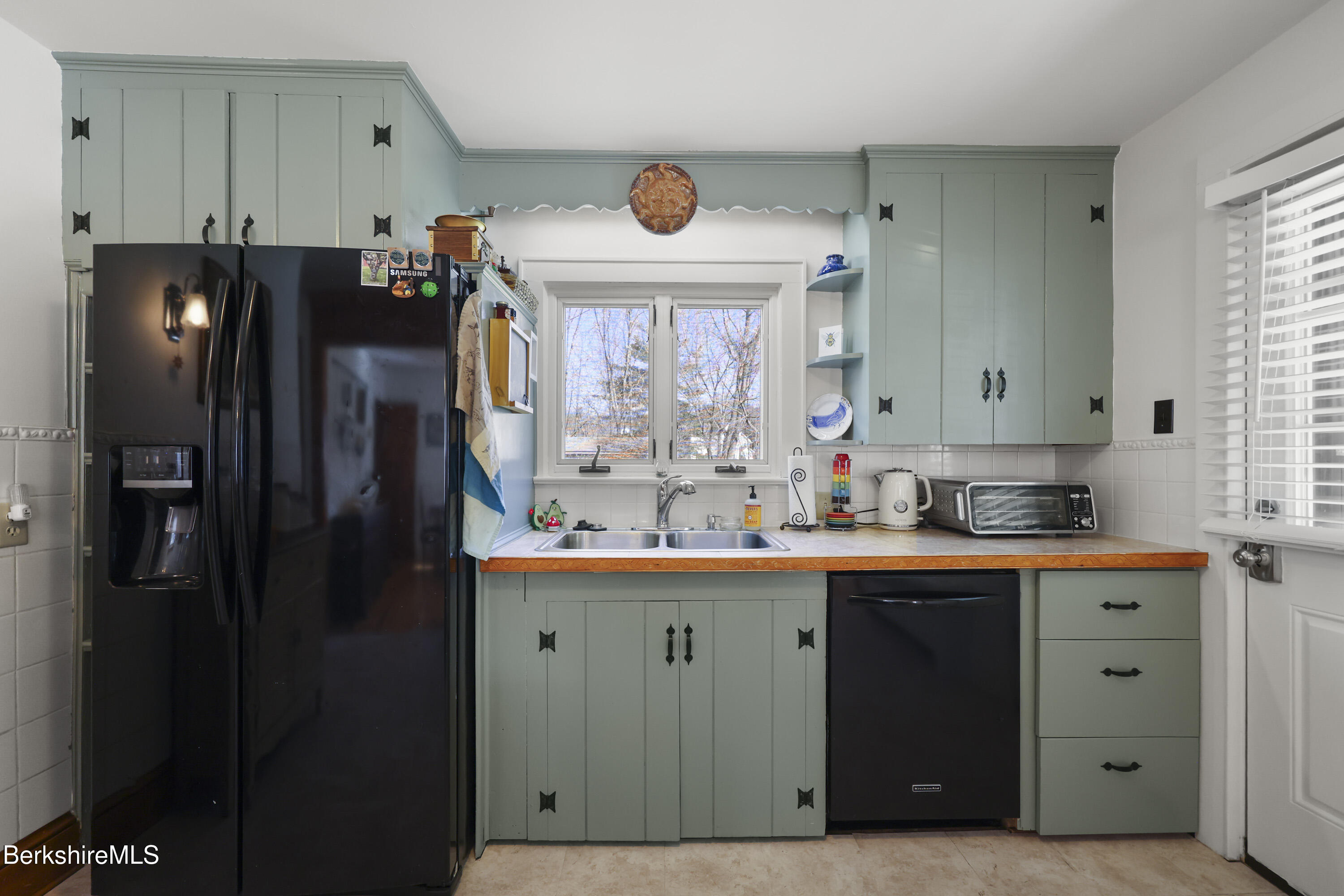 39 Lowden Street Pittsfield, MA 01201 - Photo 14 of 42 a kitchen with stainless steel appliances a refrigerator and a sink
