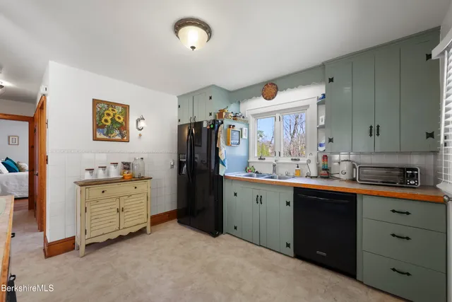 a kitchen with cabinets a refrigerator and a sink