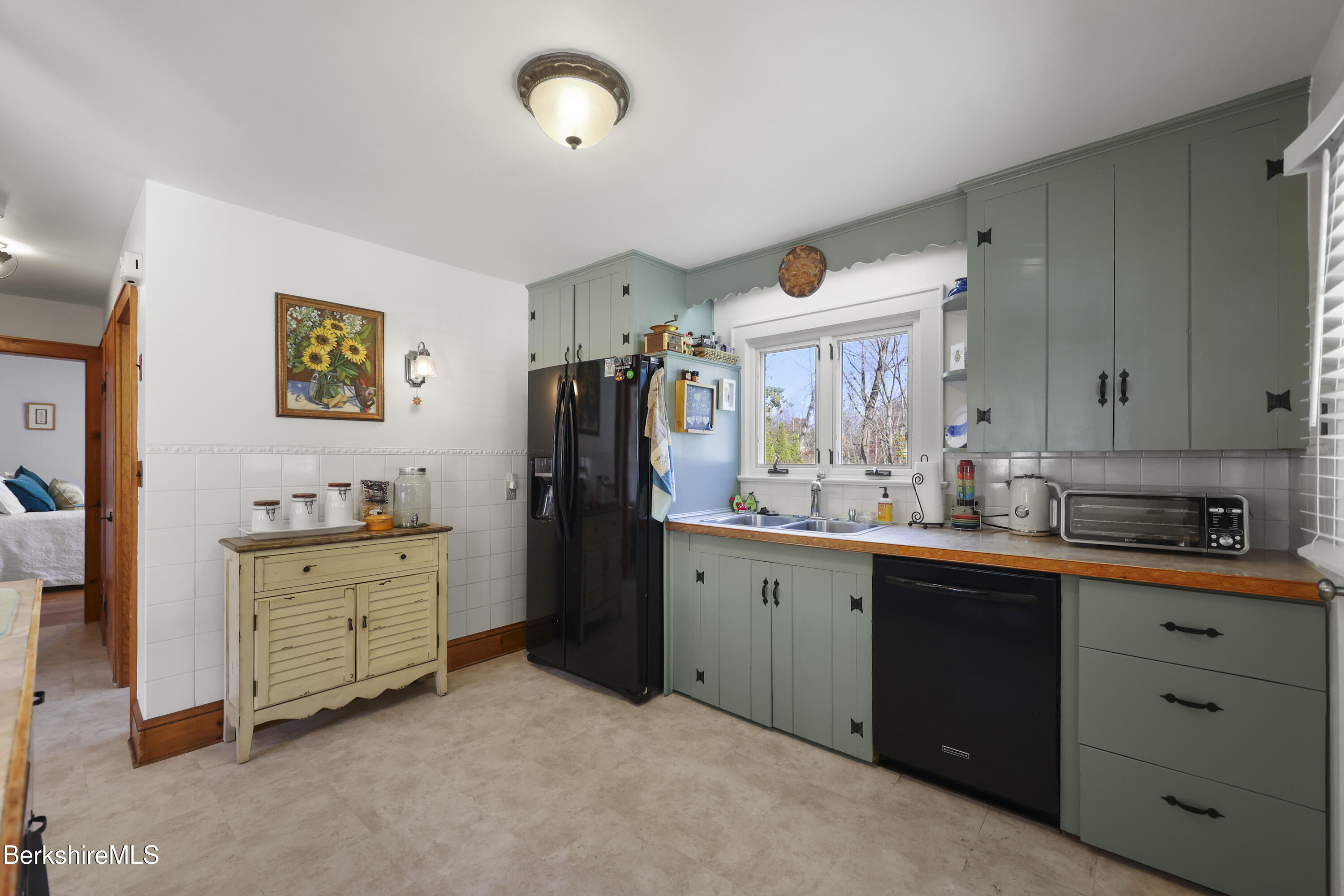 39 Lowden Street Pittsfield, MA 01201 - Photo 15 of 42 a kitchen with cabinets a refrigerator and a sink