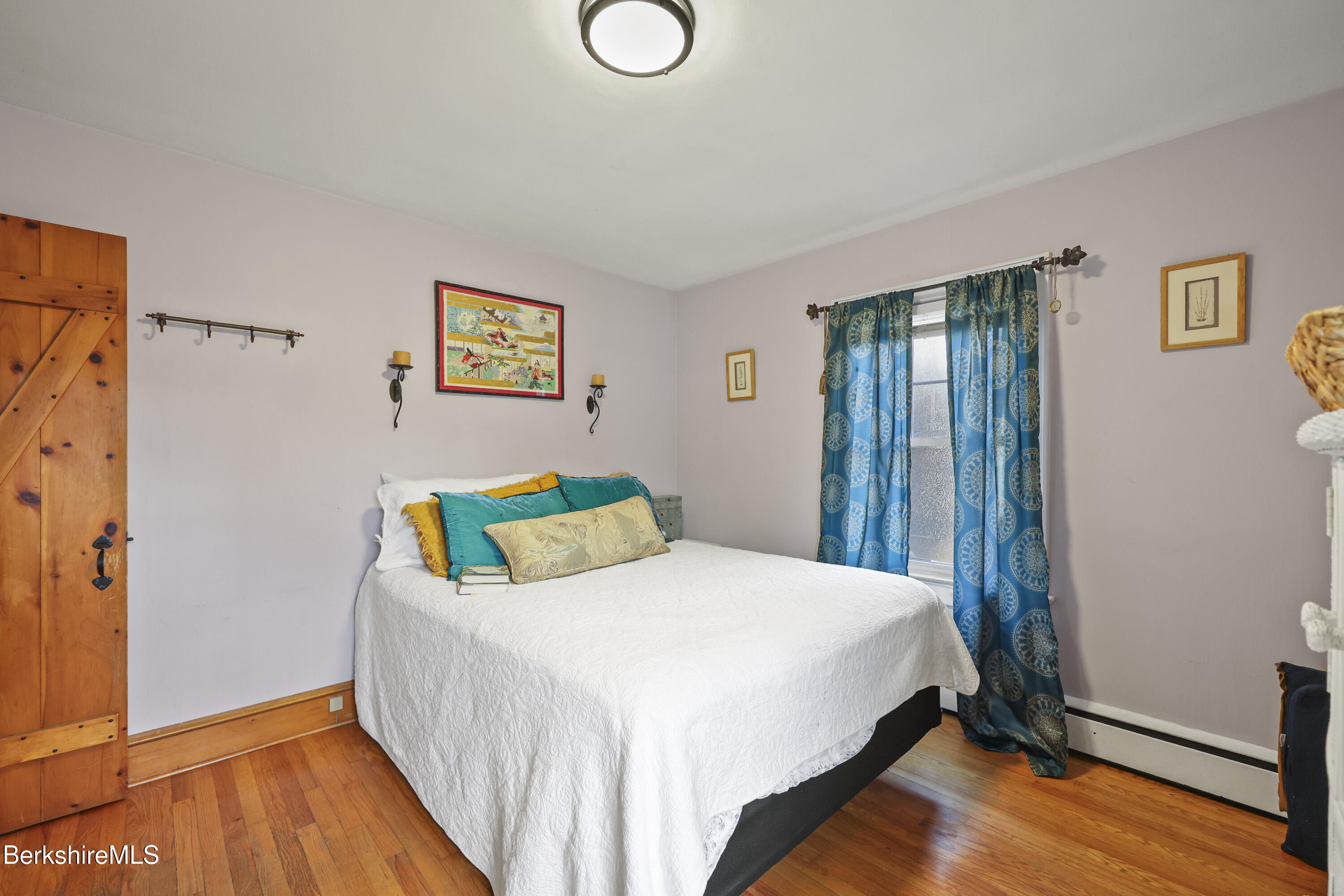 39 Lowden Street Pittsfield, MA 01201 - Photo 21 of 42 a bedroom with a bed and wooden floor