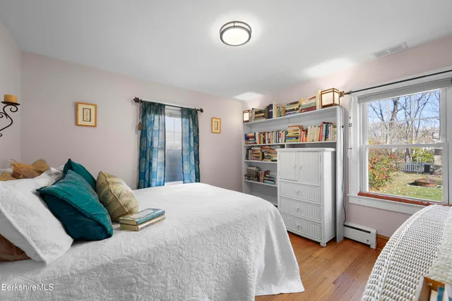 a bedroom with a bed furniture and a large window